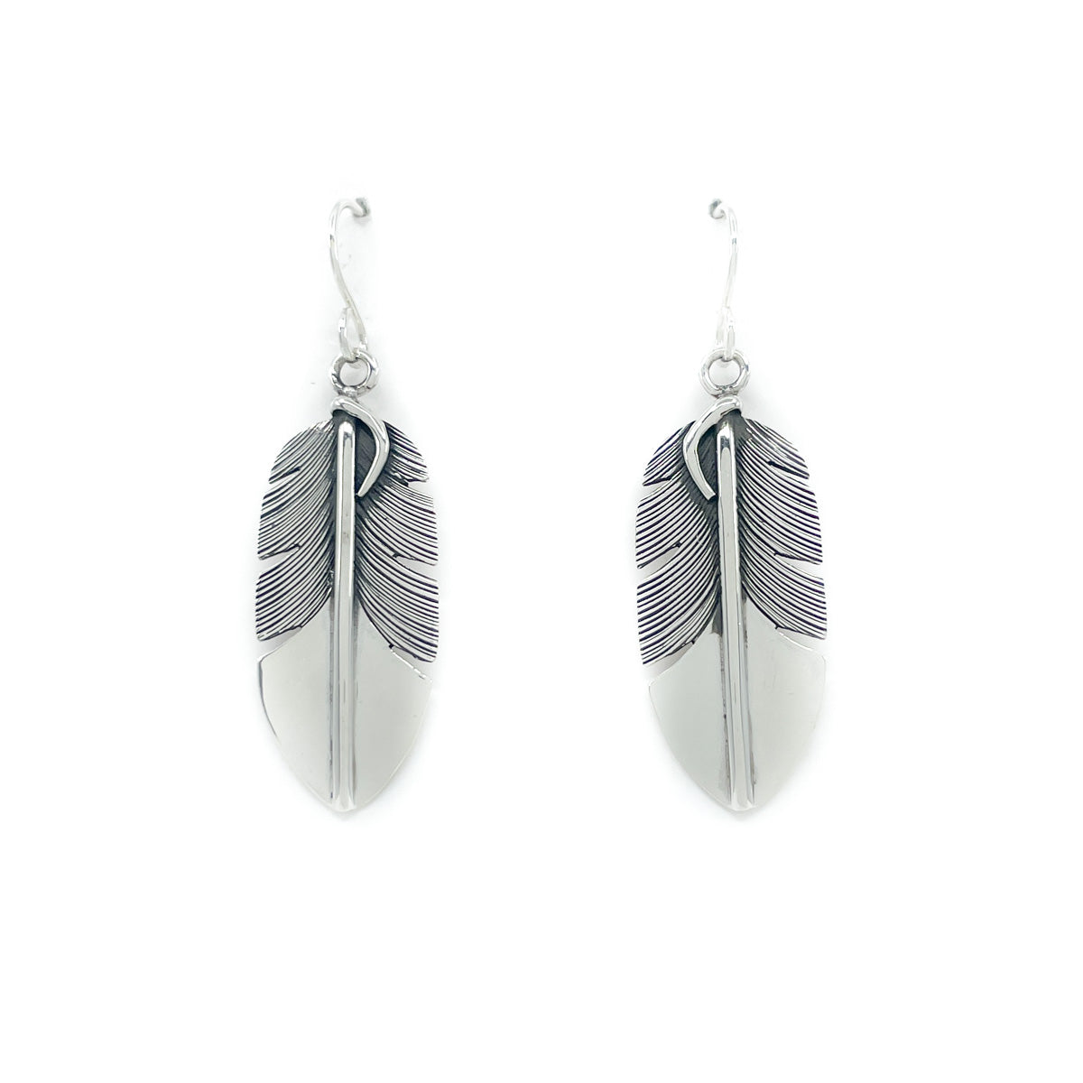Beautiful hand fabricated sterling silver feather earrings with fine detail
By Diné (Navajo) jeweler Lena Platero
Feathers measure approx. 1.5 inches long and .50 inches wide
Earrings dangle approx. 2 inches long from the ear lobe
Sterling silver wires