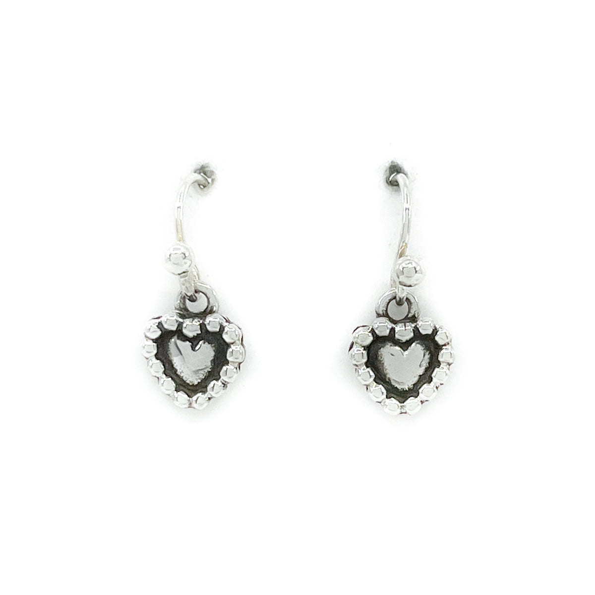Sterling silver handcrafted heart shaped earrings - very delicate!&nbsp;
Measures approximately .25 by .25 inches, dangles .75 inches from earlobe
Sterling silver wires