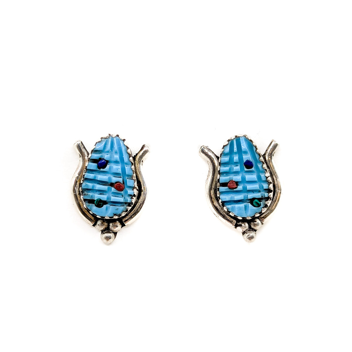 Handcrafted sterling silver and carved turquoise corn earrings with tiny coral, lapis, jet or malachite accents by Tracy Bowekaty, Zuni jeweler&nbsp;
Each earring measures approximately .50 inches long by .50 inches wide

Sterling silver posts and backs