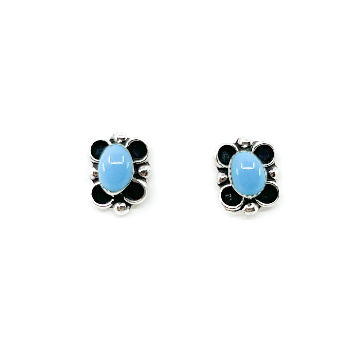 Sterling&nbsp;Silver and Turquoise stud earrings
Handcrafted by Zuni&nbsp;artist, Cora Cachini
Earrings are approximately .50 inches&nbsp;long&nbsp;x .25 inches wide&nbsp;

Sterling Silver&nbsp;posts