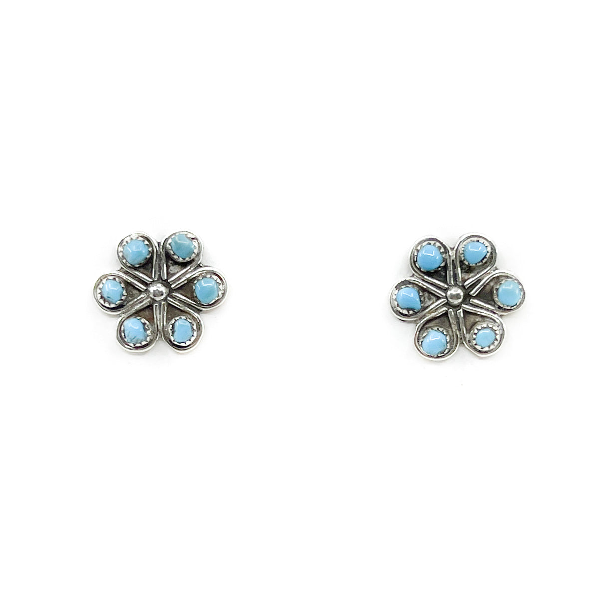 Sterling Silver oxidized and polished Turquoise flower earrings Handcrafted by Zuni artist,&nbsp;Herbert Lastiyano Measures approximately .50 inch in diameter 6 hand cut turquoise stones, sterling silver posts and backs
