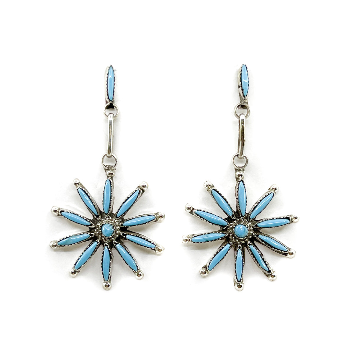 Star-shaped earrings with blue accents on a white background