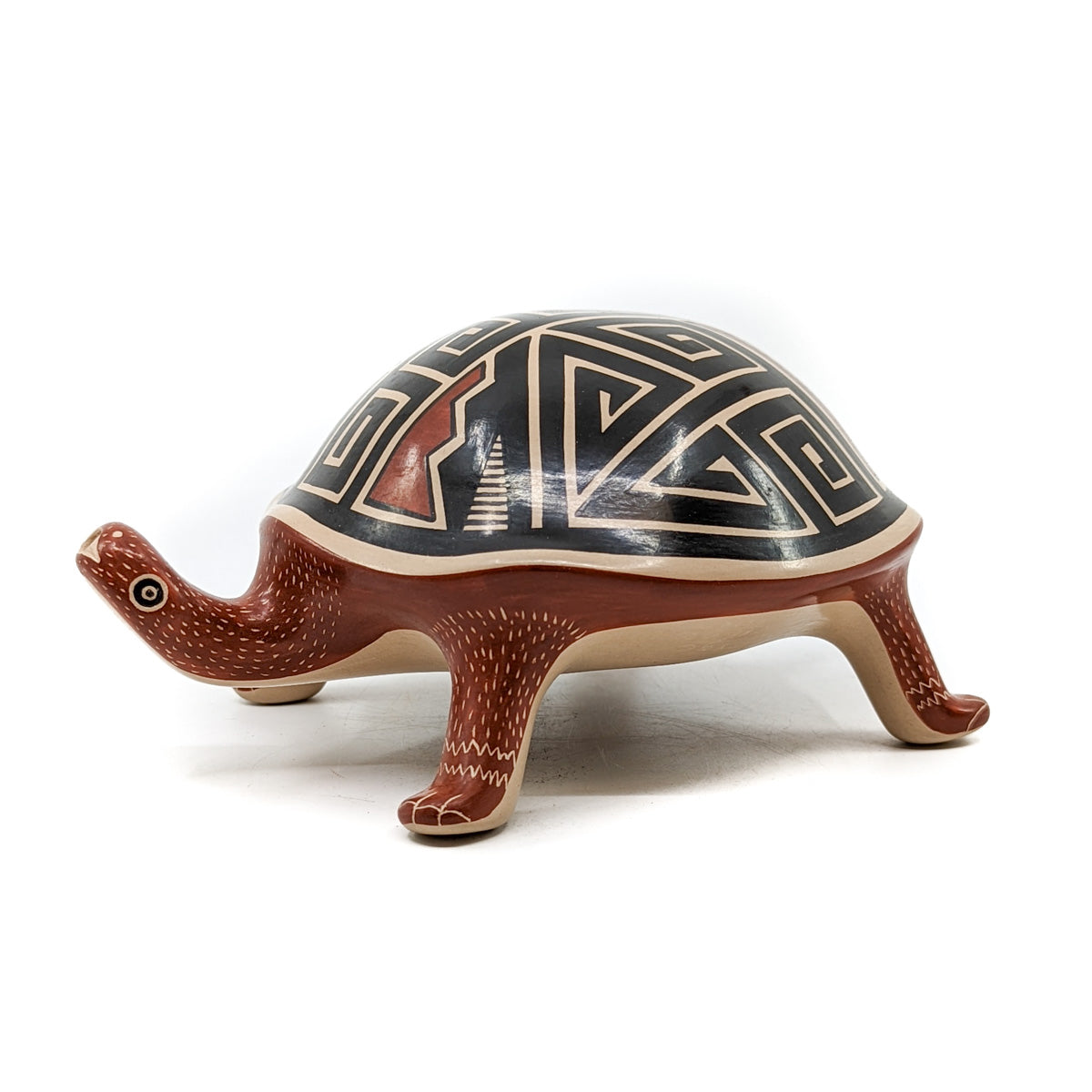 Handcrafted pot by Mata Ortiz artist, Jorge Corona&nbsp;
Polychrome turtle figure with a geometric design
Measures approximately inches 3.5 high x 8 inches long from head to tail x 5.5 inches in diameter