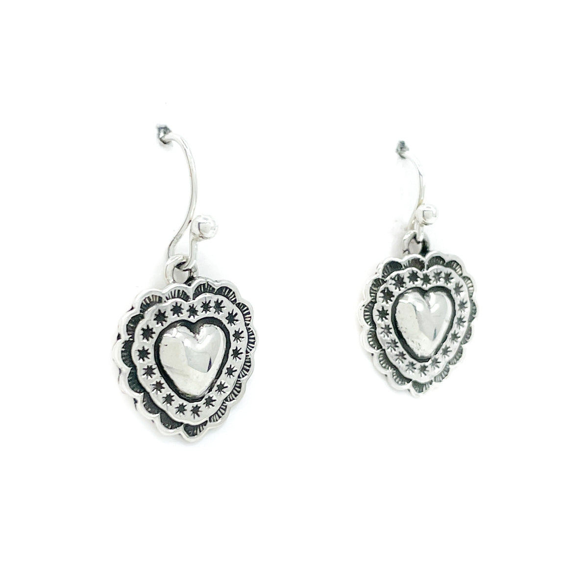 Sterling silver hand stamped heart earrings with sterling wires
Nice heavy gauge silver, but comfortable to wear, by Raymond Coriz, Diné artist
Measures approx. .50 inches in diameter and dangles form earlobe approx. 1 inch