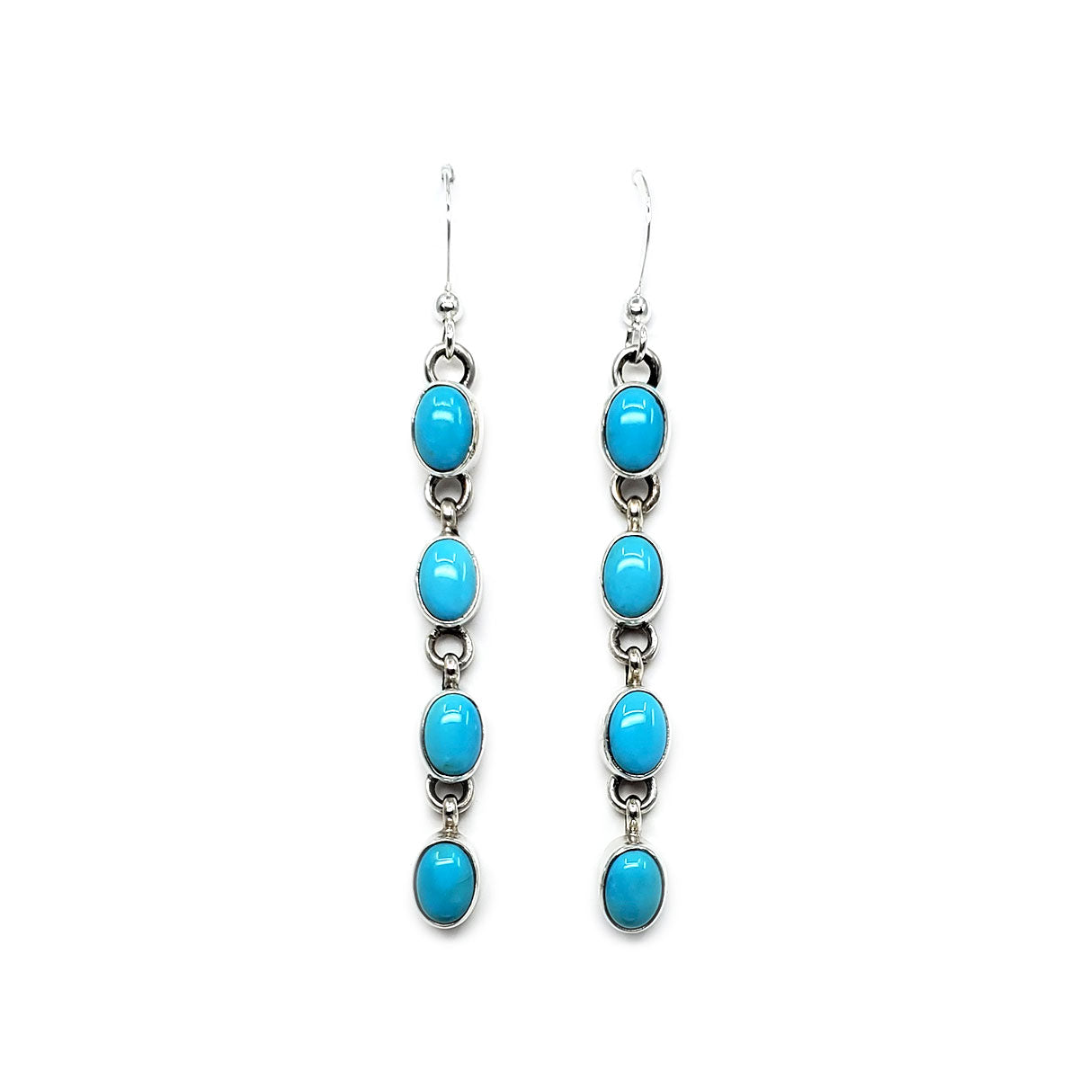 Hand crafted by Diné artist Rose S. Paxton
4 oval Sleeping Beauty turquoise stones set in sterling silver bezels
Each stone measures approx .25 x .25 inches
Sterling silver French hooks and findings
Earrings dangle approx&nbsp; 2.25 inches long from earlobe