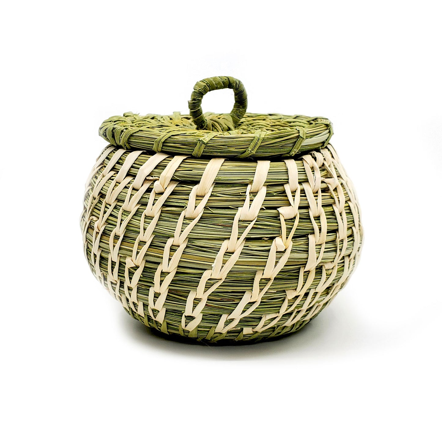This handwoven basket is by Tohono O'Odham artist Fred Cruz from Sells, Arizona. Basket measures 3 inches tall plus 1 inch for the lid handle and 3.25 inches in diameter. Lid is removable for storage inside basket.  Plant materials are hand gathered from the Sonoran Desert. Green coils are native beargrass and the white, open stitches are of sun bleached yucca.